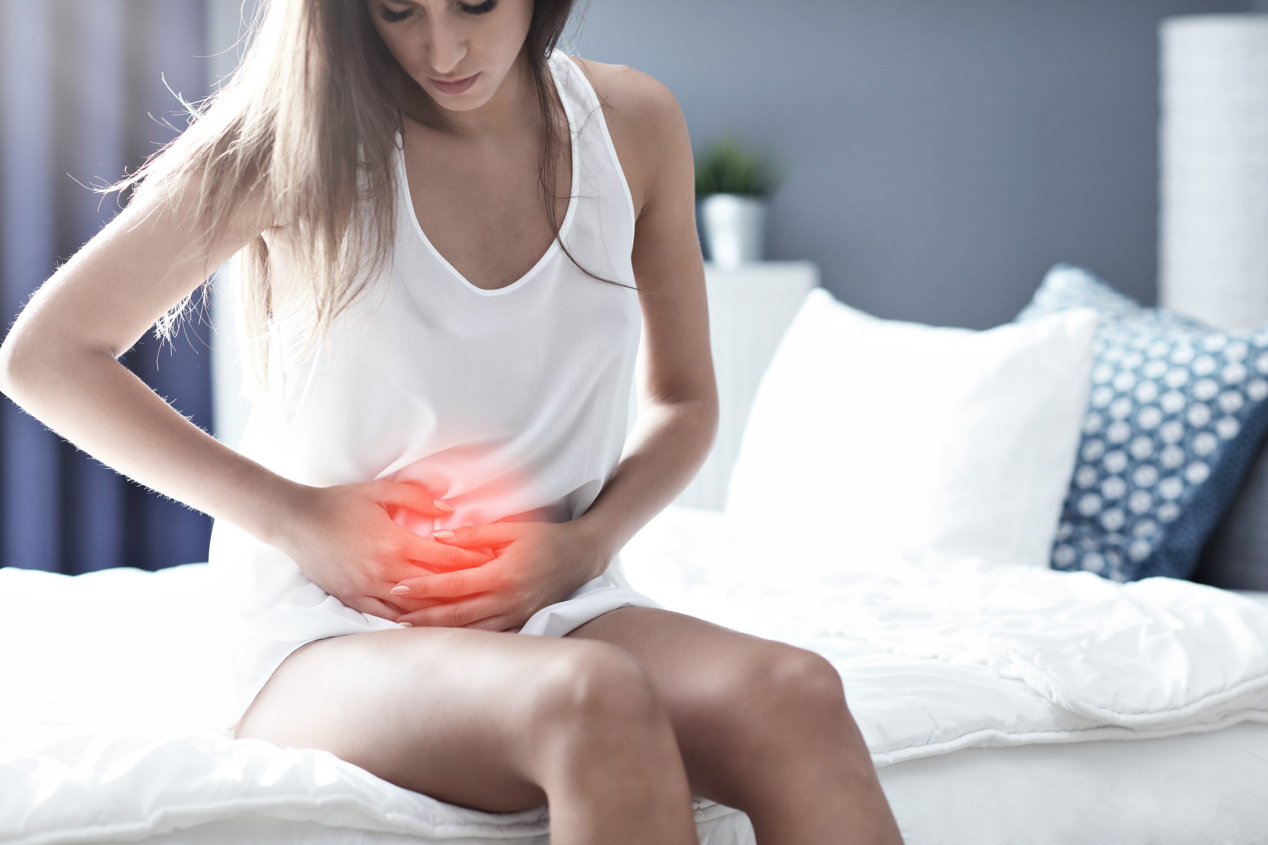 Adult woman waking up in the morning feeling sick